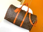 Louis Vuitton Keepall Bandoulière 50 in Monogram canvas with orange leather accents