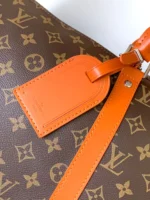 Louis Vuitton Keepall Bandoulière 50 in Monogram canvas with orange leather accents - Image 4