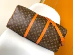 Louis Vuitton Keepall Bandoulière 50 in Monogram canvas with orange leather accents - Image 3