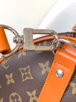 Louis Vuitton Keepall Bandoulière 50 in Monogram canvas with orange leather accents - Image 5