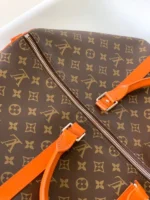 Louis Vuitton Keepall Bandoulière 50 in Monogram canvas with orange leather accents - Image 7